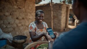 Woman Accepting Central Bank Digital Currency (CBDC) Payment via Smartphone in Rural Market